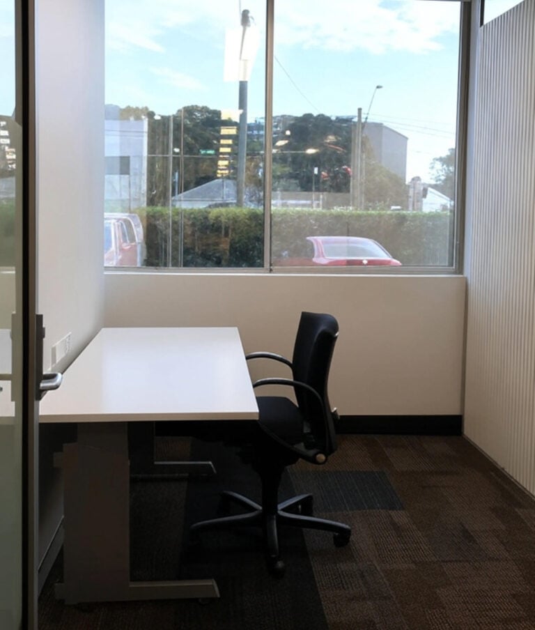 Private one person office in Sydney with desk, chair, and natural light