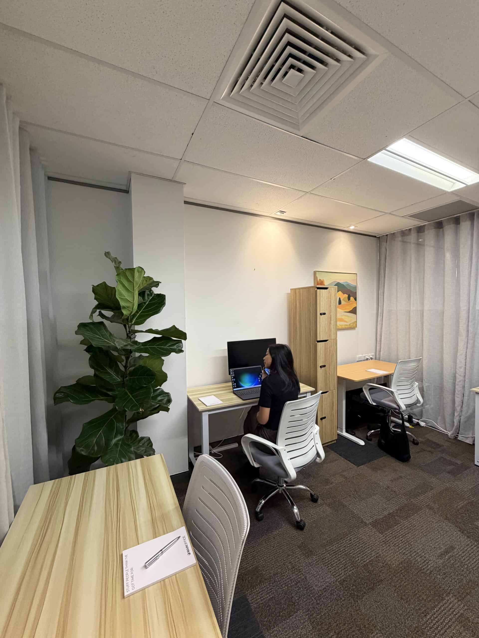 Bright coworking desks with plants